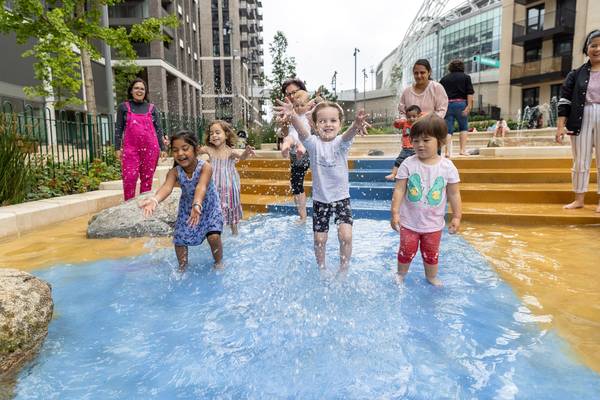 Children playing in Union Park paddling pool in Wembley Park