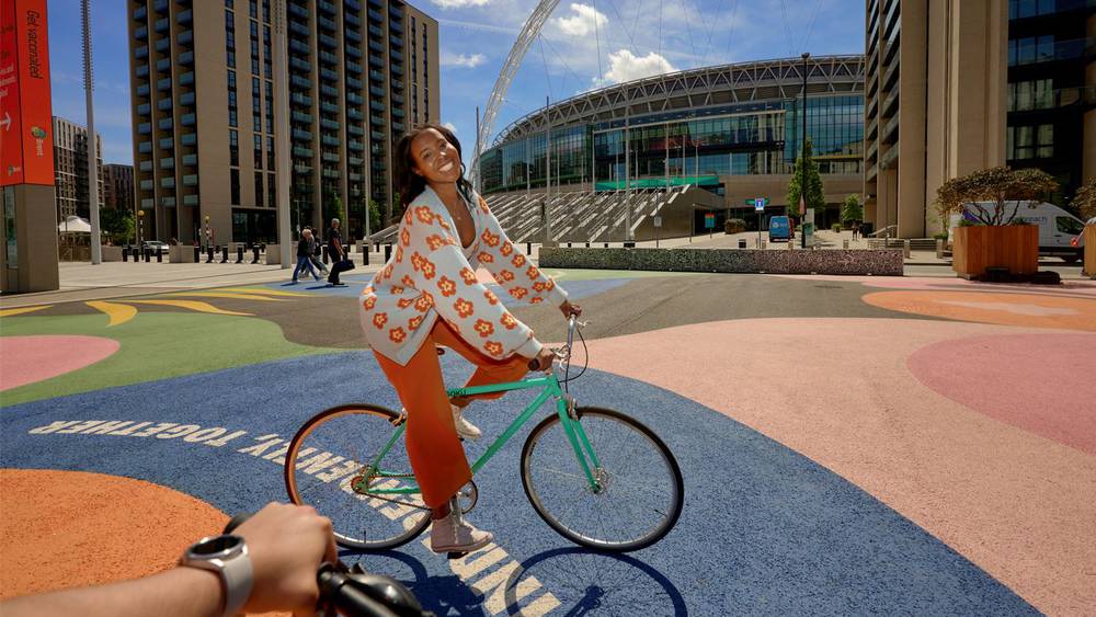 Cycling in Wembley Park on Lois OHara Think Independently Together Artwork