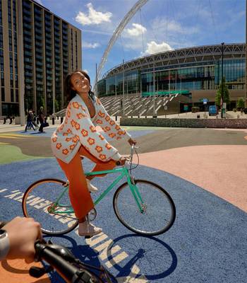 Cycling in Wembley Park on Lois OHara Think Independently Together Artwork