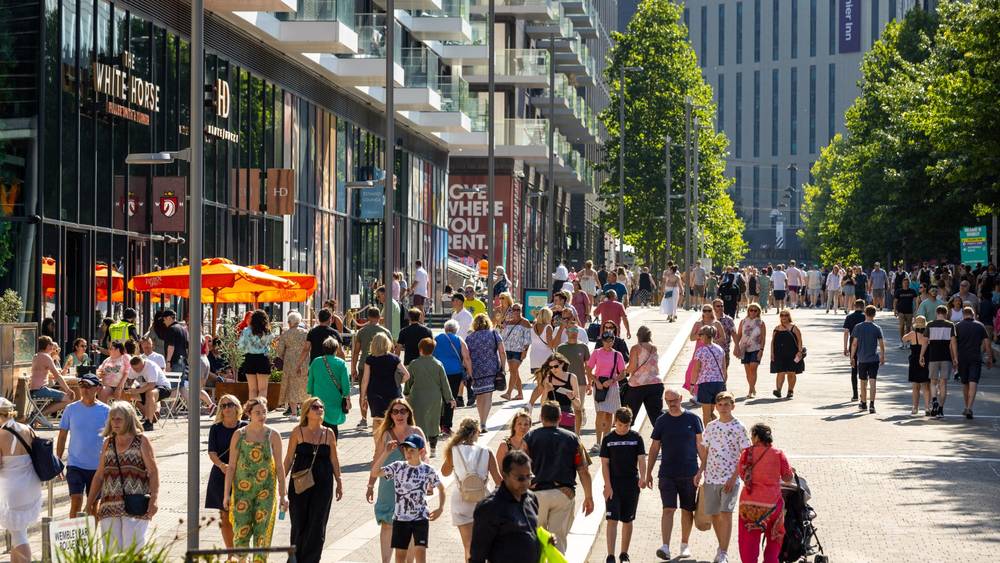 Wembley Park Boulevard busy with visitors on a summer event day, White Horse and Estadio Lounge visible