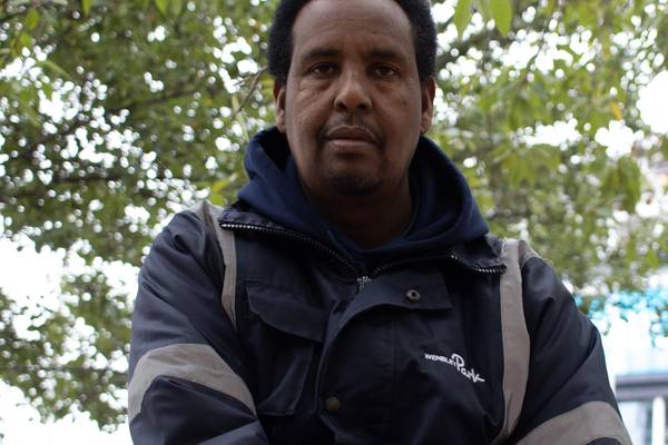 Mohammed Siad of Wembley Park's cleaning team in a reflective Wembley Park jacket, beneath a tree in Wembley Park