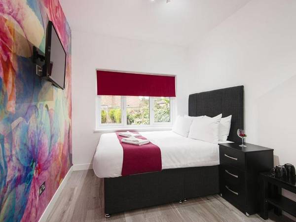Wembley Park Hotel bedroom with vivid floral mural feature wall, by Wembley Park, London