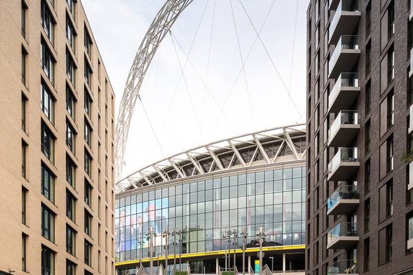 Full view of YELLOW 25 by Wembley Park x Pantone on the Spanish Steps, celebrating 25 years of Coldplay’s Yellow, with Wembley Stadium arch in the bac